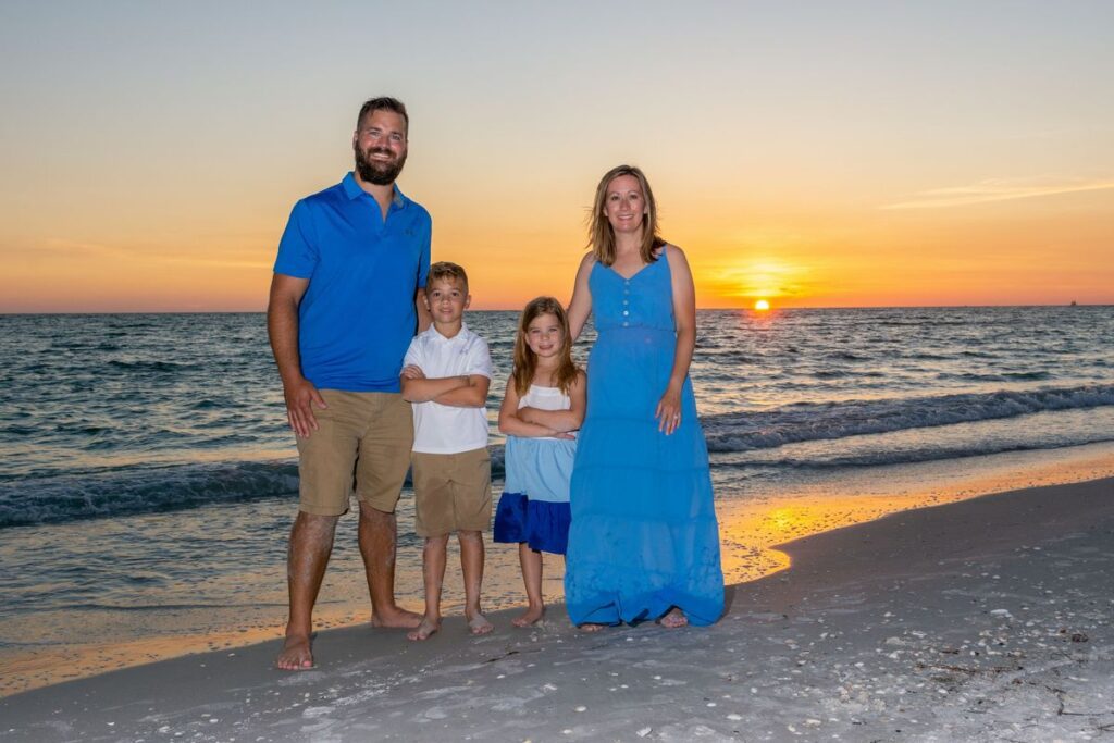 “Sunset beach photography session in Madeira Beach Florida with golden sky and calm waves”